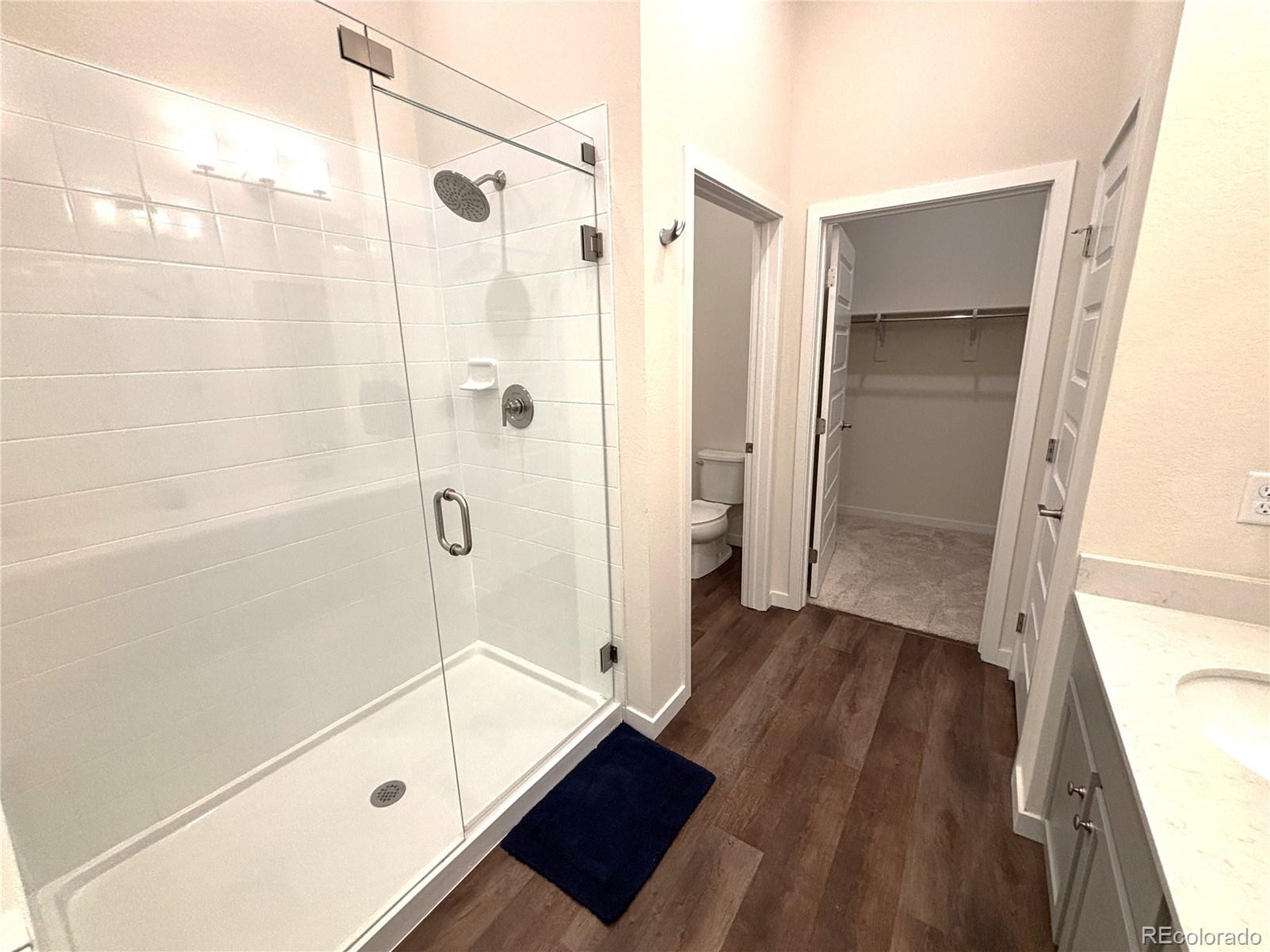 437 Interlocken Boulevard, Unit 102 Broomfield, CO 80021 - Photo 10 of 27 a bathroom with a glass shower door