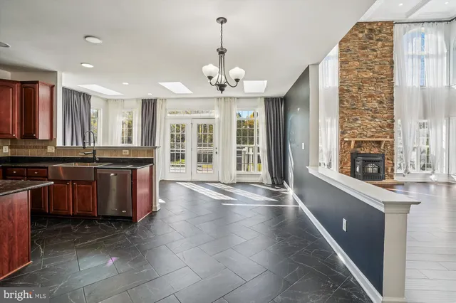 a bathroom with a granite countertop sink a mirror and a bathtub