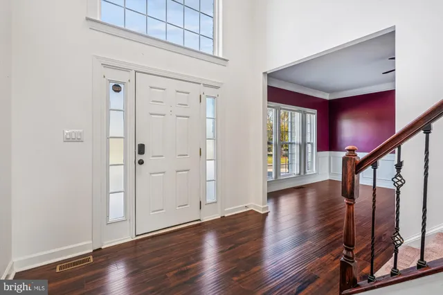 a view of an entryway with wooden floor and door