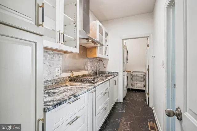 a view of a hallway with wooden floor and stairs
