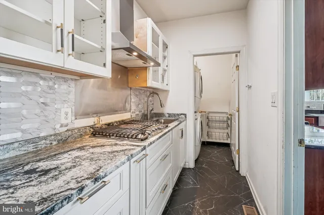 a view of a livingroom with wooden floor and a fireplace