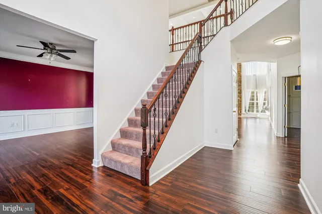a view of entryway and hall with wooden floor