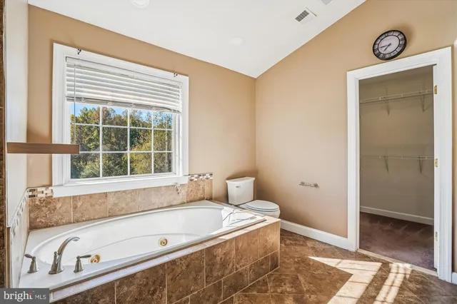 a view of a livingroom with a flat screen tv and floor to ceiling window