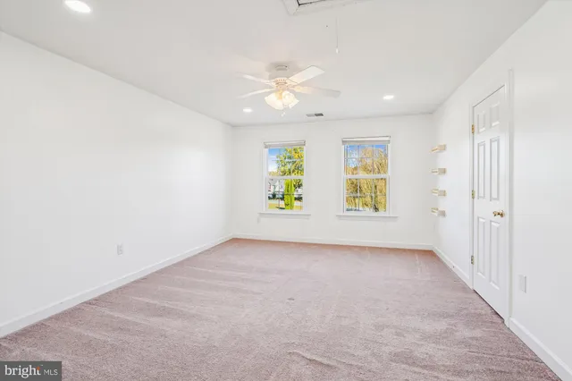 a view of a field of grass and trees