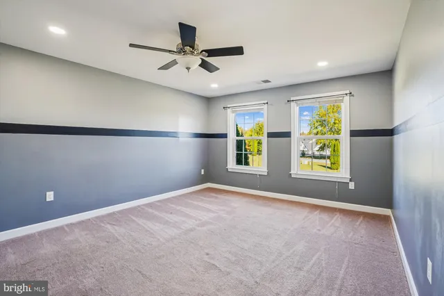 a front view of a house with swimming pool and porch