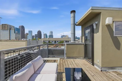 a view of roof deck with two chairs and a barbeque