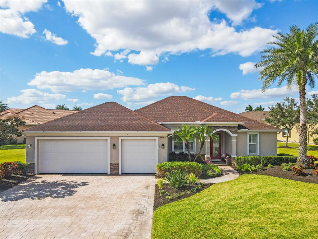 19709 Cobblestone Circle Venice, FL 34292 - Photo 1 of 44 a front view of a house with yard patio and fire pit