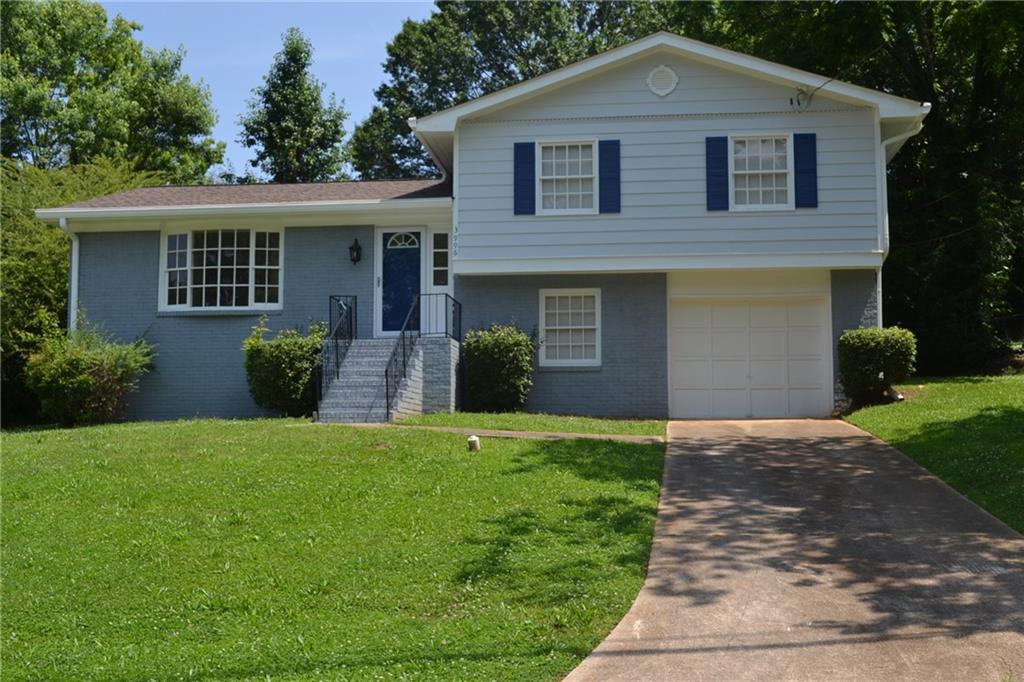 3996 Snapfinger Way Decatur, GA 30035 - Photo 1 of 1 a front view of a house with a yard and potted plants