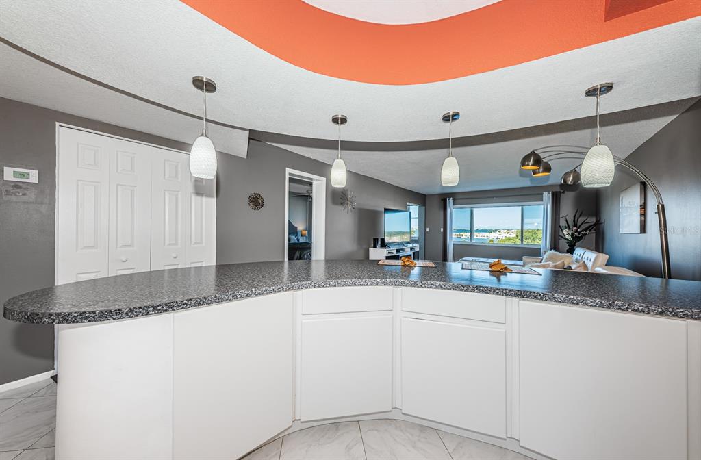 4725 Cove Circle, Unit 604 St. Petersburg, FL 33708 - Photo 12 of 53 a kitchen with stainless steel appliances granite countertop a sink and a refrigerator