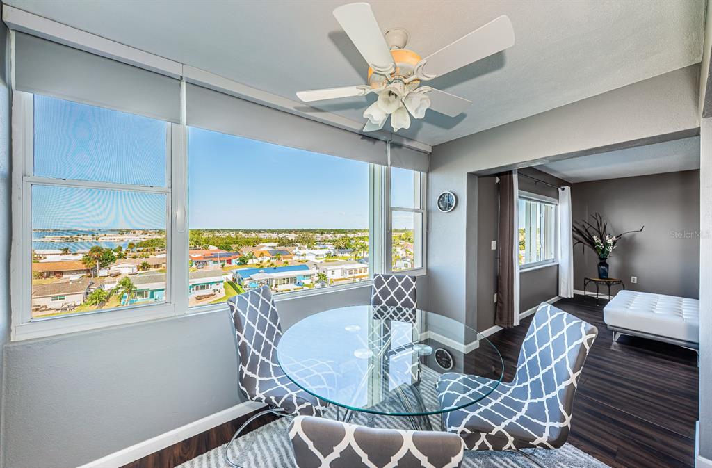 4725 Cove Circle, Unit 604 St. Petersburg, FL 33708 - Photo 22 of 53 a living room with furniture a chandelier and a large window