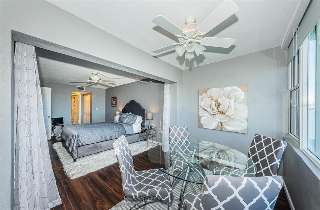 4725 Cove Circle, Unit 604 St. Petersburg, FL 33708 - Photo 24 of 53 a living room with furniture and a chandelier