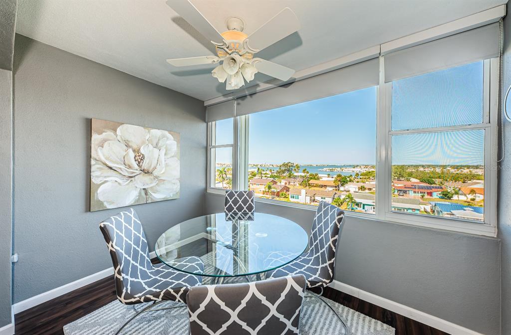 4725 Cove Circle, Unit 604 St. Petersburg, FL 33708 - Photo 25 of 53 a dining room with furniture a rug and a large window