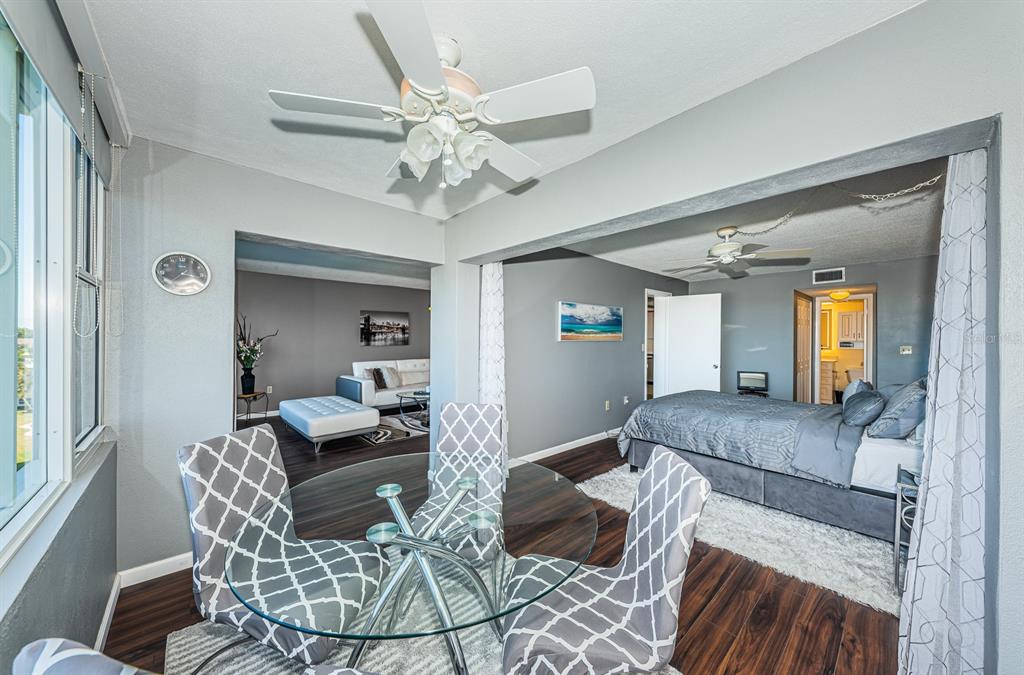 4725 Cove Circle, Unit 604 St. Petersburg, FL 33708 - Photo 28 of 53 a living room with furniture and a chandelier
