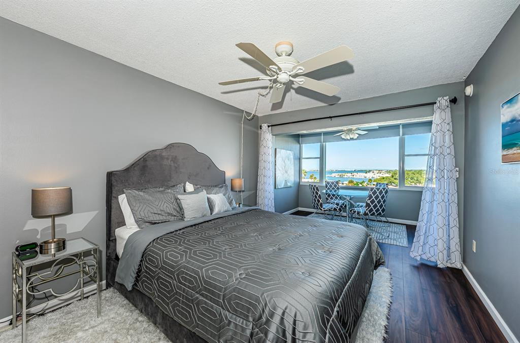 4725 Cove Circle, Unit 604 St. Petersburg, FL 33708 - Photo 29 of 53 a bedroom with a bed and a chandelier
