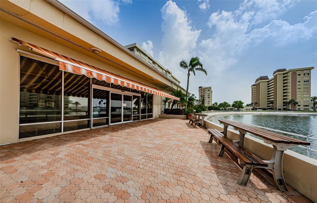 4725 Cove Circle, Unit 604 St. Petersburg, FL 33708 - Photo 39 of 53 a view of a balcony with chairs and a floor to ceiling window