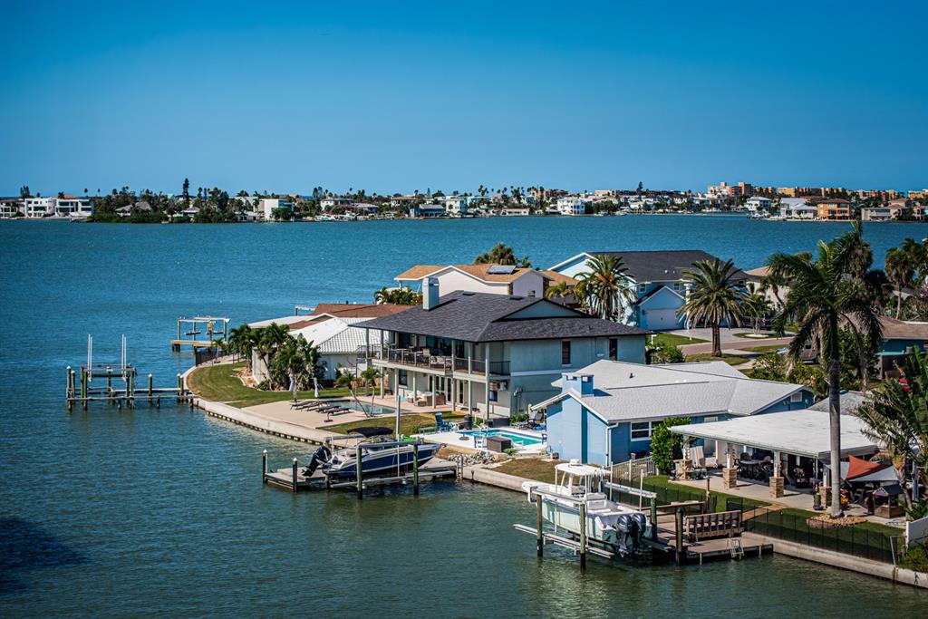 4725 Cove Circle, Unit 604 St. Petersburg, FL 33708 - Photo 4 of 53 a view of a lake with a table and chairs