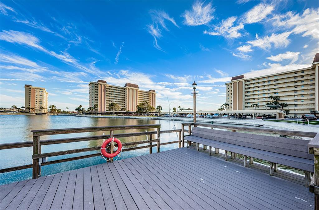 4725 Cove Circle, Unit 604 St. Petersburg, FL 33708 - Photo 42 of 53 a view of a balcony with wooden floor and city view