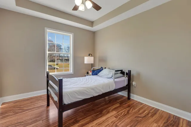 a bedroom with a bed and a chandelier