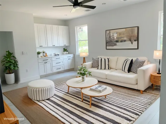 a living room with furniture and a rug