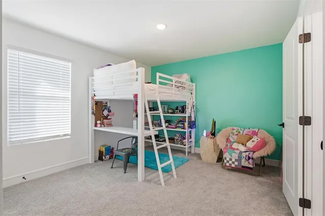 a bedroom with bed and a window