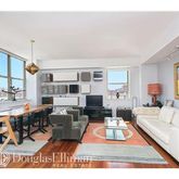 a living room with furniture a rug and a large window