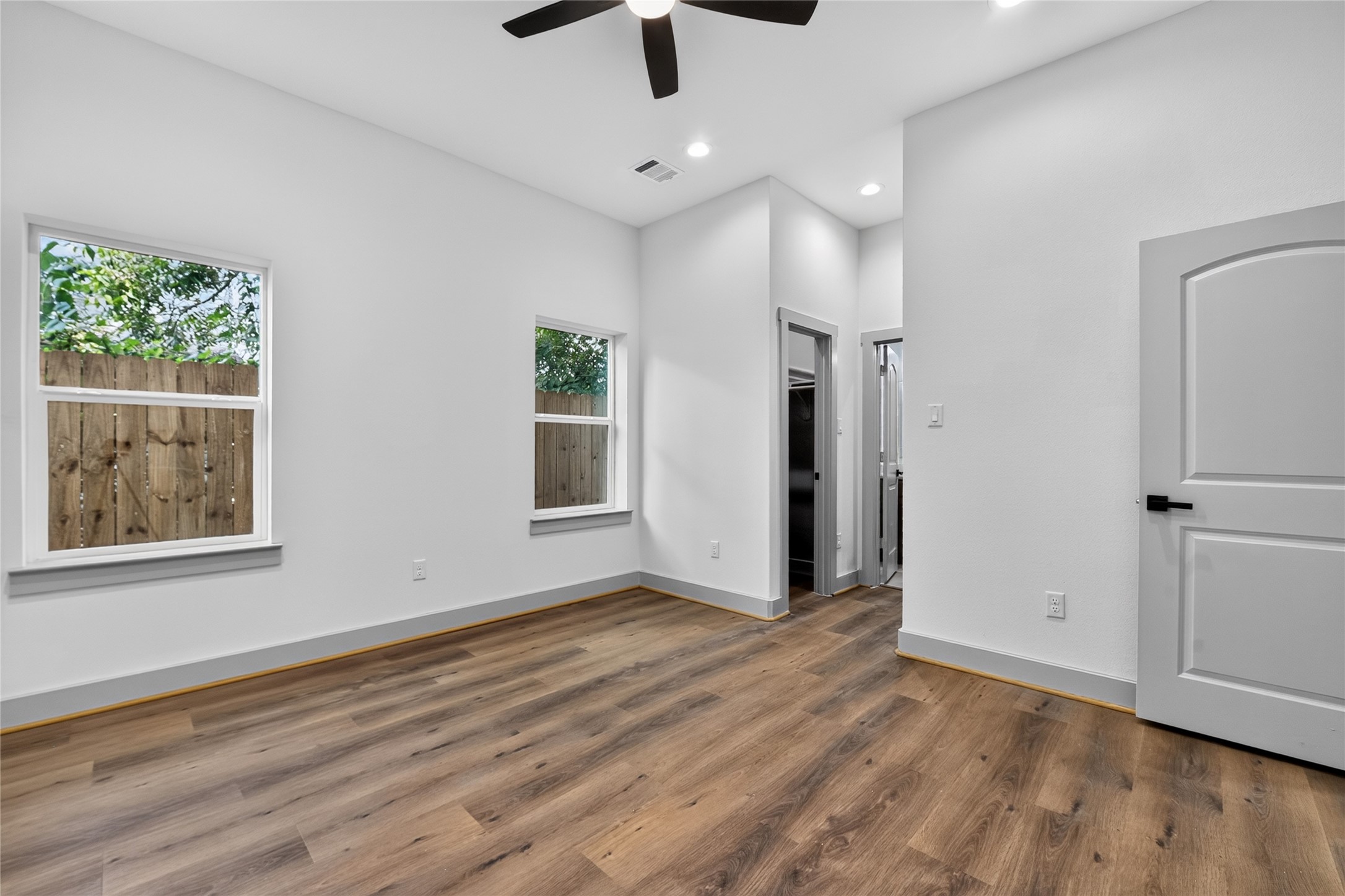 6815 Stearns Street Houston, TX 77021 - Photo 16 of 35 A serene main-level sanctuary has generous windows that frame peaceful views while bathing the primary suite in bright elegance—offering main-floor convenience with an airy, refined feel.