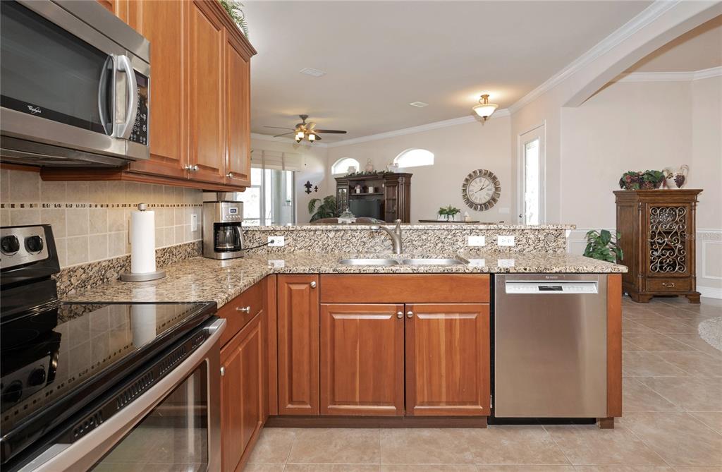 202 Lourdan Court DeBary, FL 32713 - Photo 12 of 38 a kitchen with stainless steel appliances granite countertop a sink and a stove