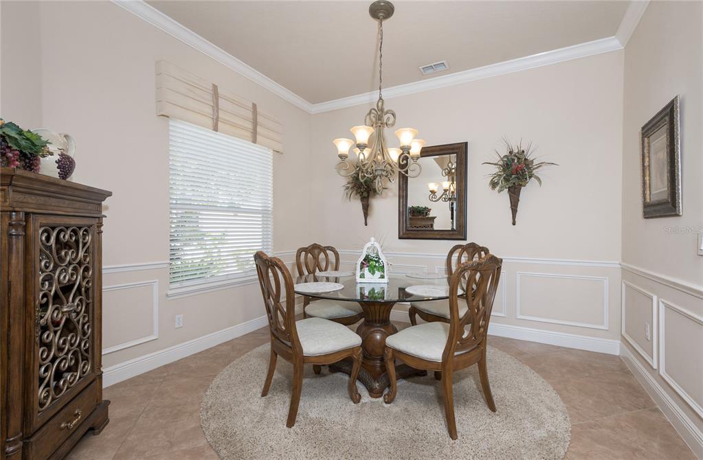 202 Lourdan Court DeBary, FL 32713 - Photo 19 of 38 a dining room with furniture a chandelier and window