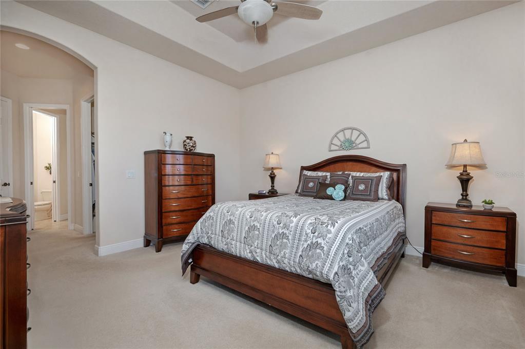 202 Lourdan Court DeBary, FL 32713 - Photo 20 of 38 a bedroom with a bed and a chandelier