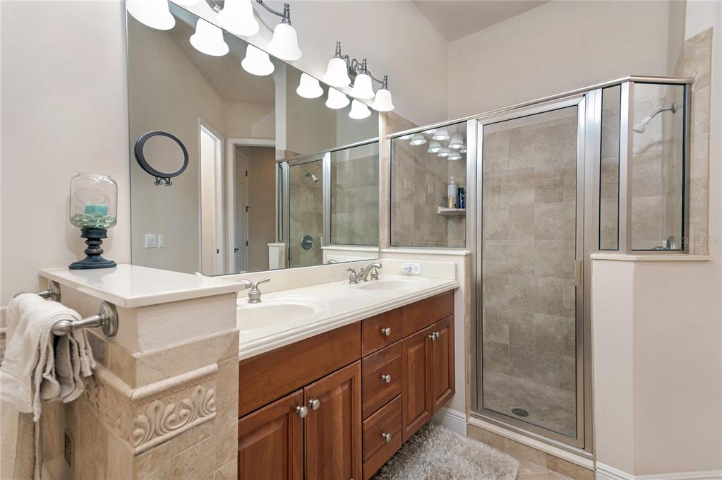 202 Lourdan Court DeBary, FL 32713 - Photo 22 of 38 a bathroom with a double vanity sink mirror and shower