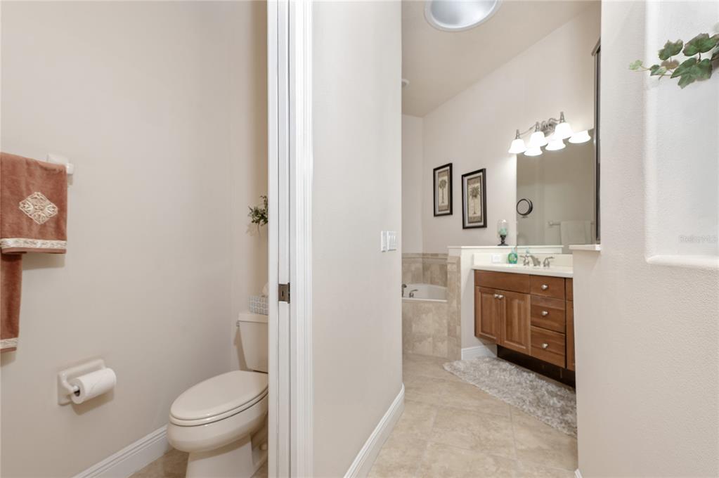 202 Lourdan Court DeBary, FL 32713 - Photo 24 of 38 a spacious bathroom with a toilet sink and mirror
