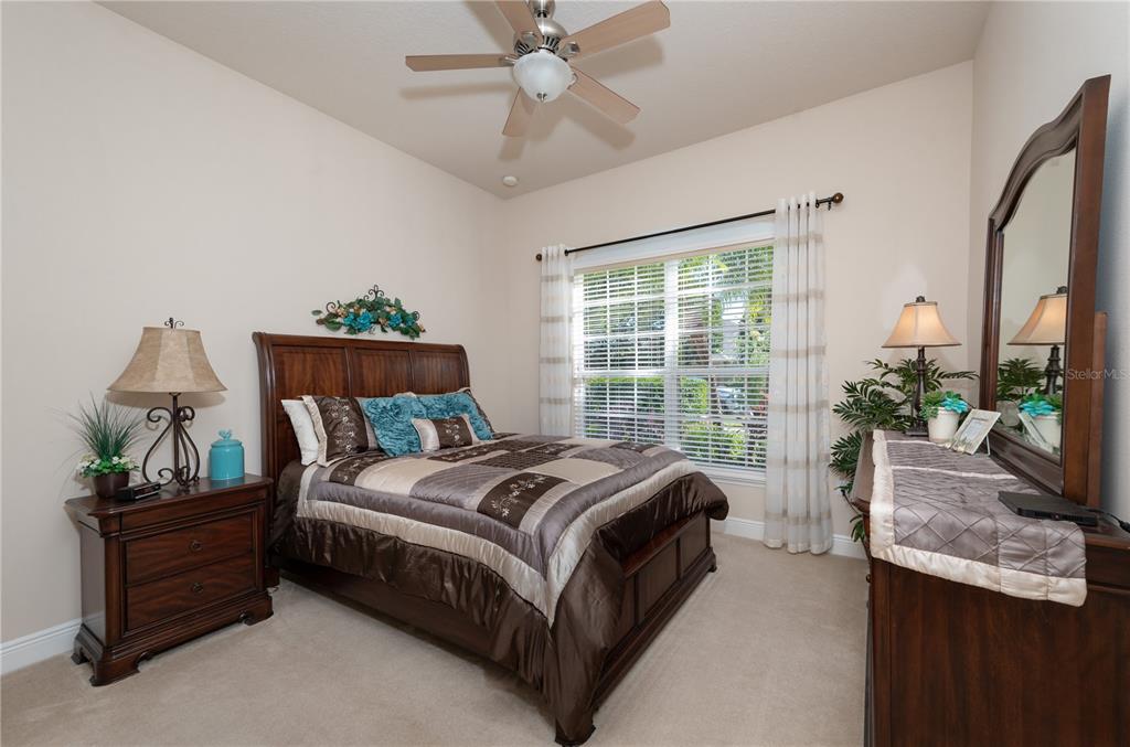 202 Lourdan Court DeBary, FL 32713 - Photo 25 of 38 a bed sitting in a bedroom next to a window