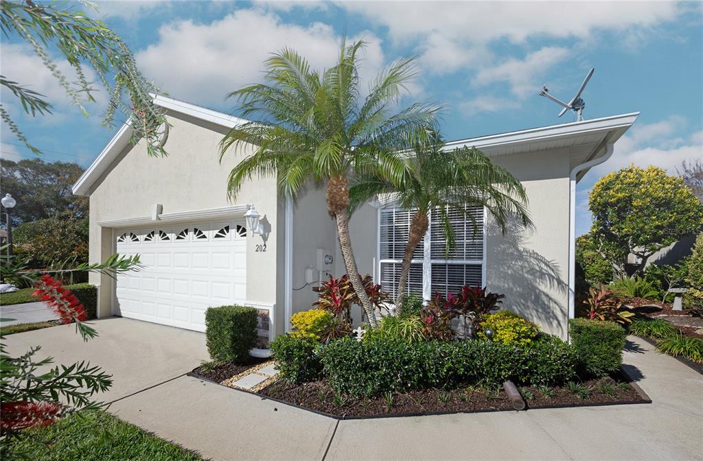 202 Lourdan Court DeBary, FL 32713 - Photo 5 of 38 a front view of a house with a yard and a garden