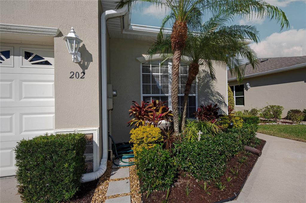 202 Lourdan Court DeBary, FL 32713 - Photo 6 of 38 a view of yellow house with potted plants