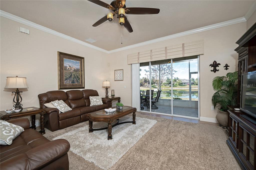 202 Lourdan Court DeBary, FL 32713 - Photo 8 of 38 a living room with furniture a flat screen tv and a large window
