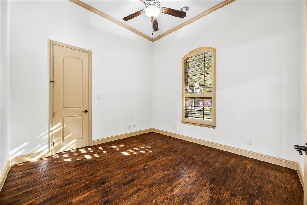 6814 Springwood Lane Garland, TX 75044 - Photo 12 of 35 a view of an empty room with window and wooden floor