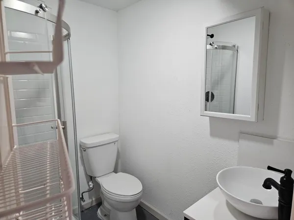 a white toilet sitting next to a bathroom sink