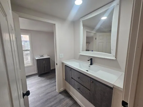 a bathroom with a sink a double vanity and a mirror
