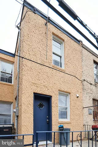 a front view of a building with table and chairs
