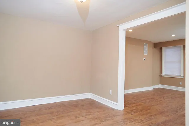 a view of a room with wooden floor