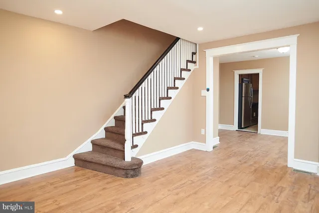 a view of entryway and hall with wooden floor