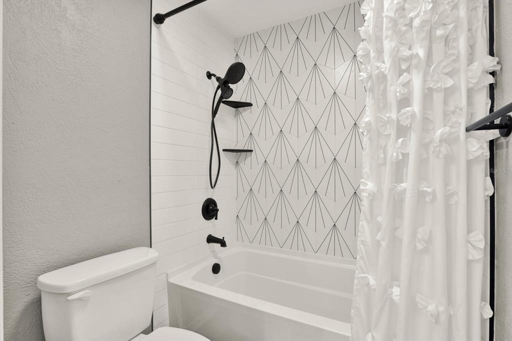 7487 River Country Drive Weeki Wachee, FL 34607 - Photo 35 of 53 a bathroom with a toilet and a tub