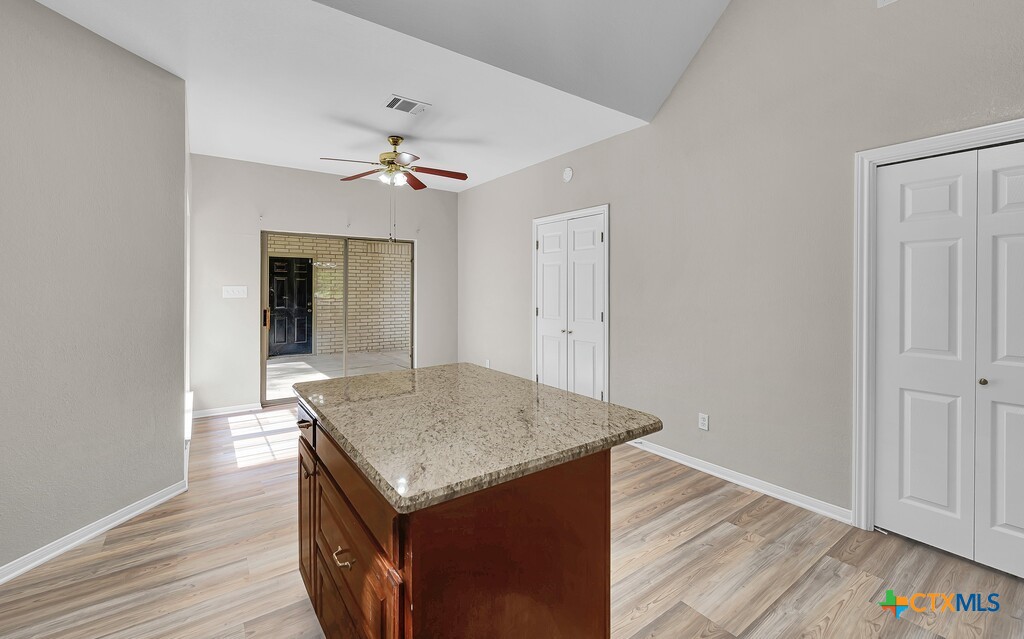 3900 Fox Ridge Road Lorena, TX 76655 - Photo 11 of 35 an empty room with wooden floor and ceiling fan