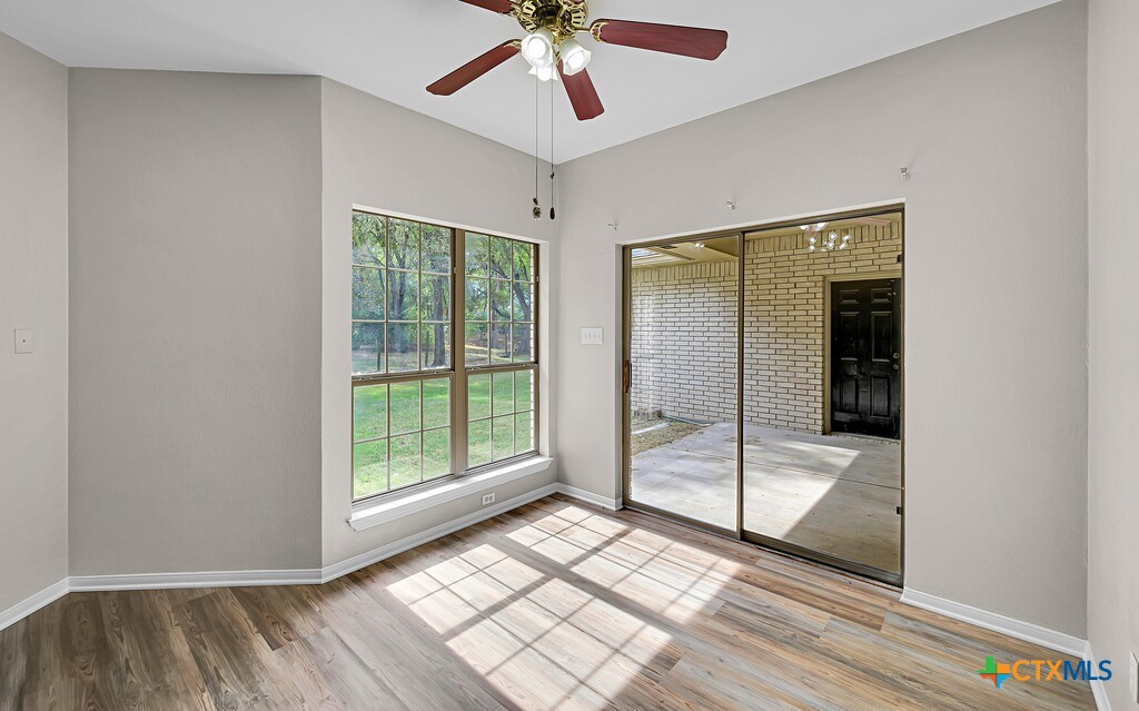 3900 Fox Ridge Road Lorena, TX 76655 - Photo 12 of 35 a view of a room with wooden floor fan and windows
