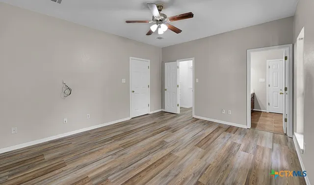 wooden floor in an empty room with a window