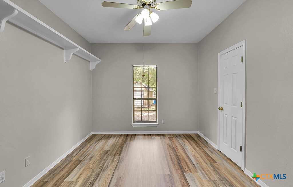 3900 Fox Ridge Road Lorena, TX 76655 - Photo 20 of 35 a view of empty room with wooden floor and fan