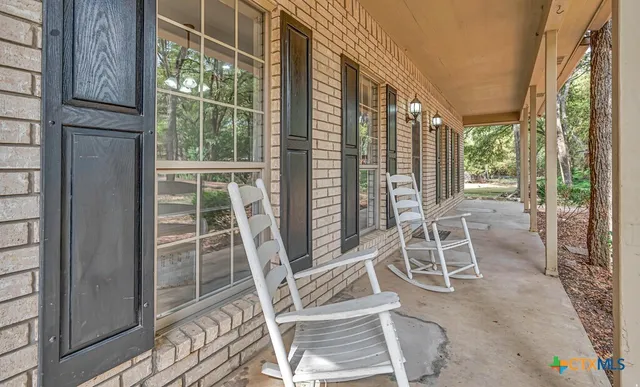 a view of a room with table and chairs