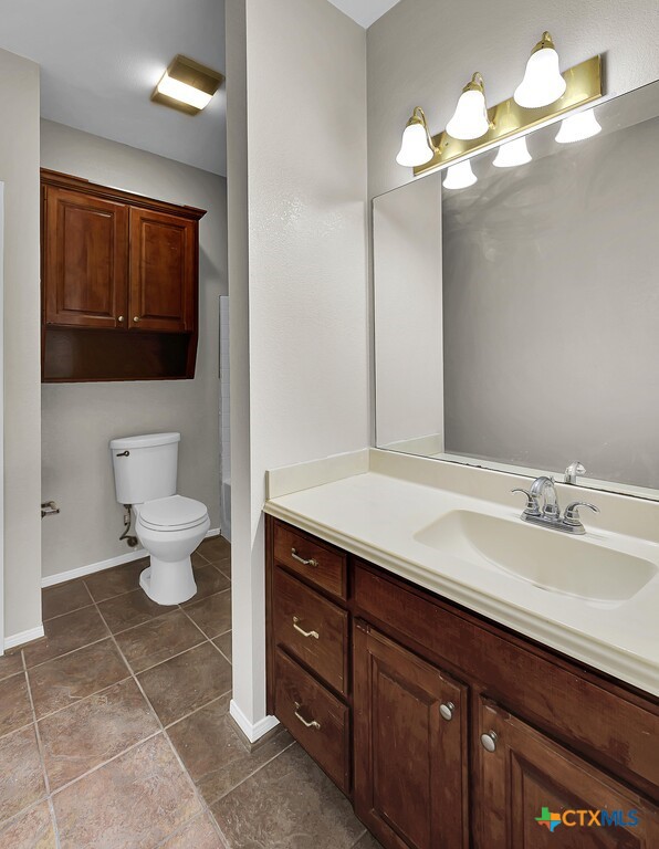 3900 Fox Ridge Road Lorena, TX 76655 - Photo 21 of 35 a bathroom with a toilet sink and mirror