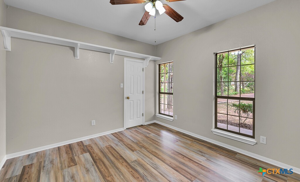 3900 Fox Ridge Road Lorena, TX 76655 - Photo 23 of 35 a view of an empty room with wooden floor and a window