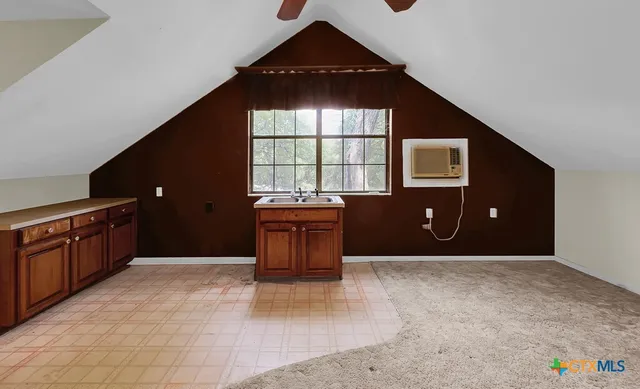 a kitchen with a refrigerator and a stove